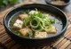 Zuppa di miso con tofu, guarnita con coriandolo fresco e semi di sesamo